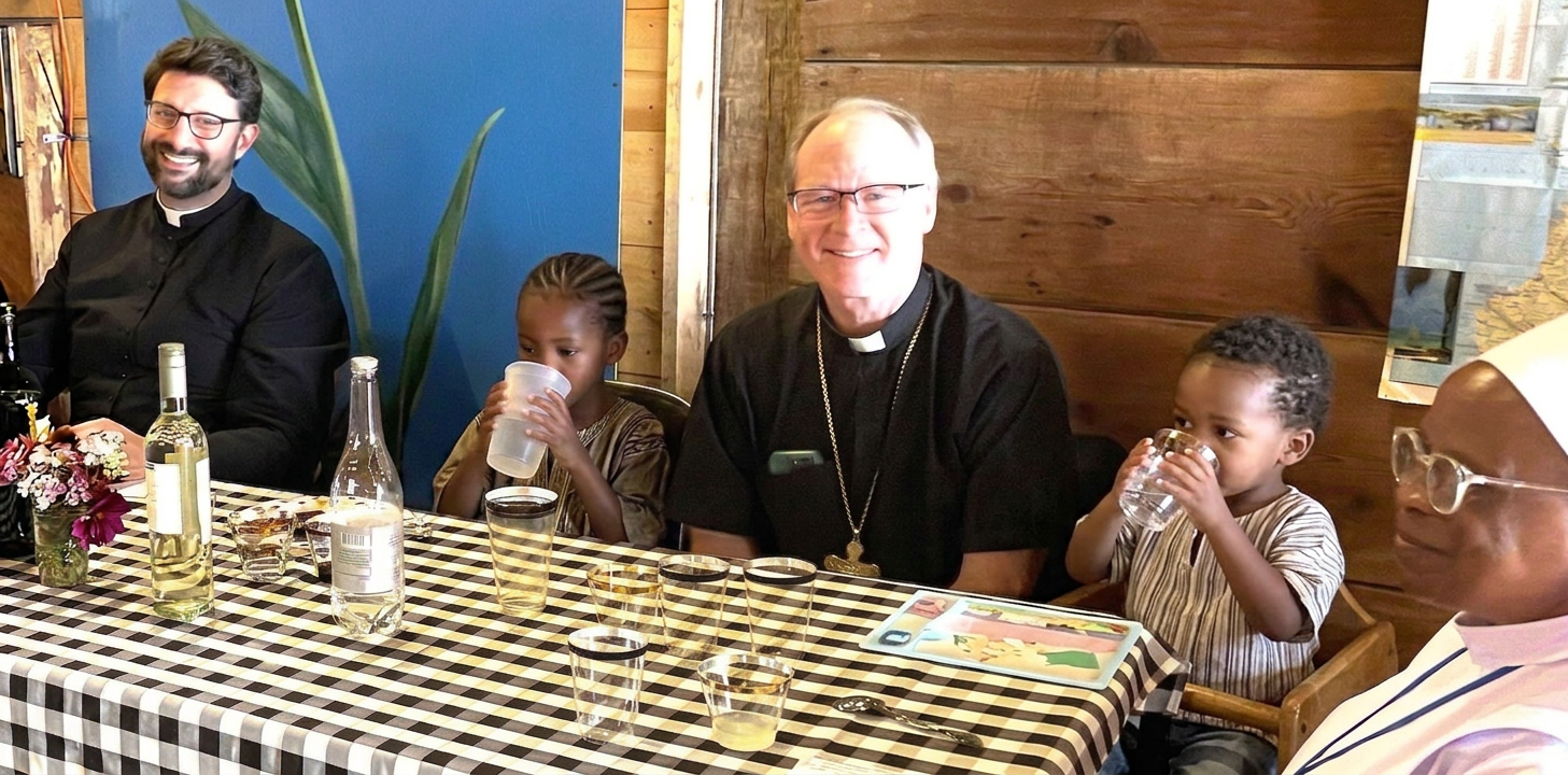 Add 3-year-old African boy drinking water beside nun Add 3-year-old African boy drinking water beside nun